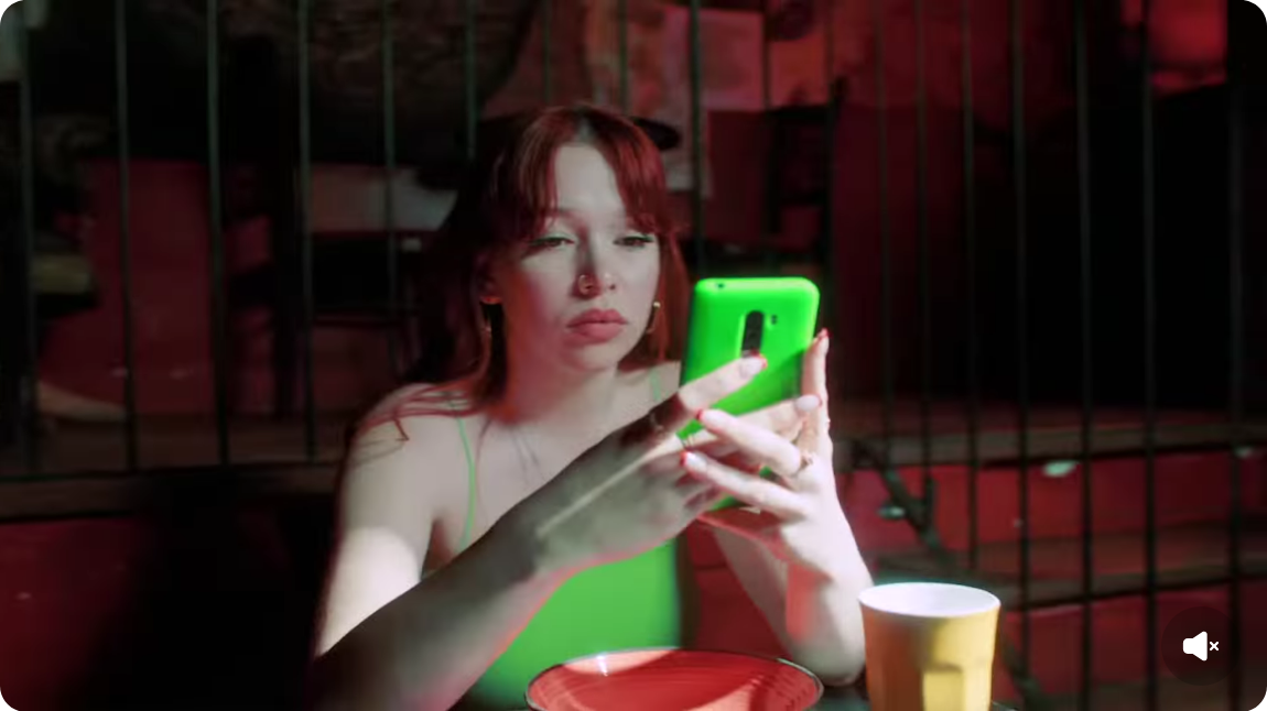 Young woman with green phone
